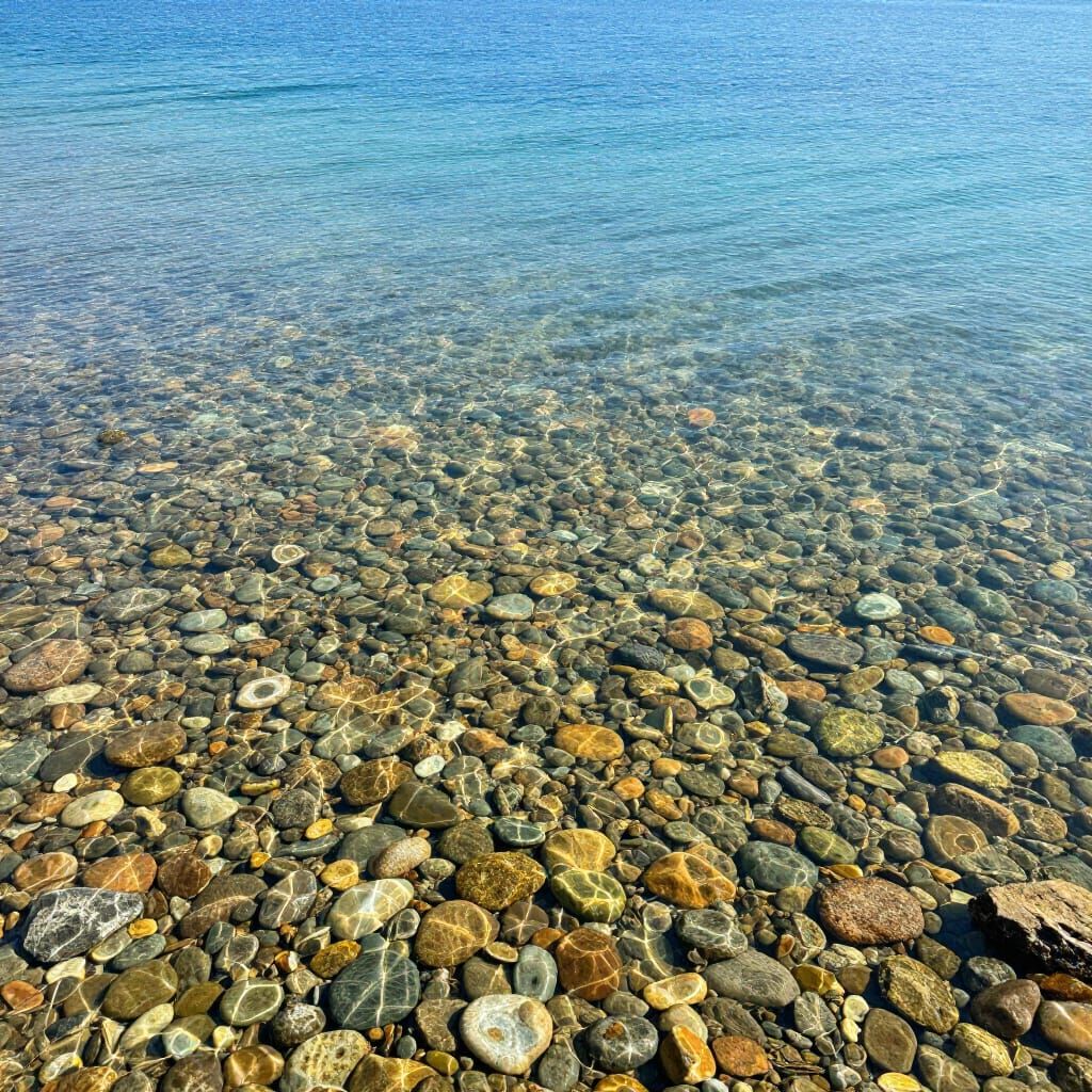 Crystal Clear Lake with Vibrant Round Rocks