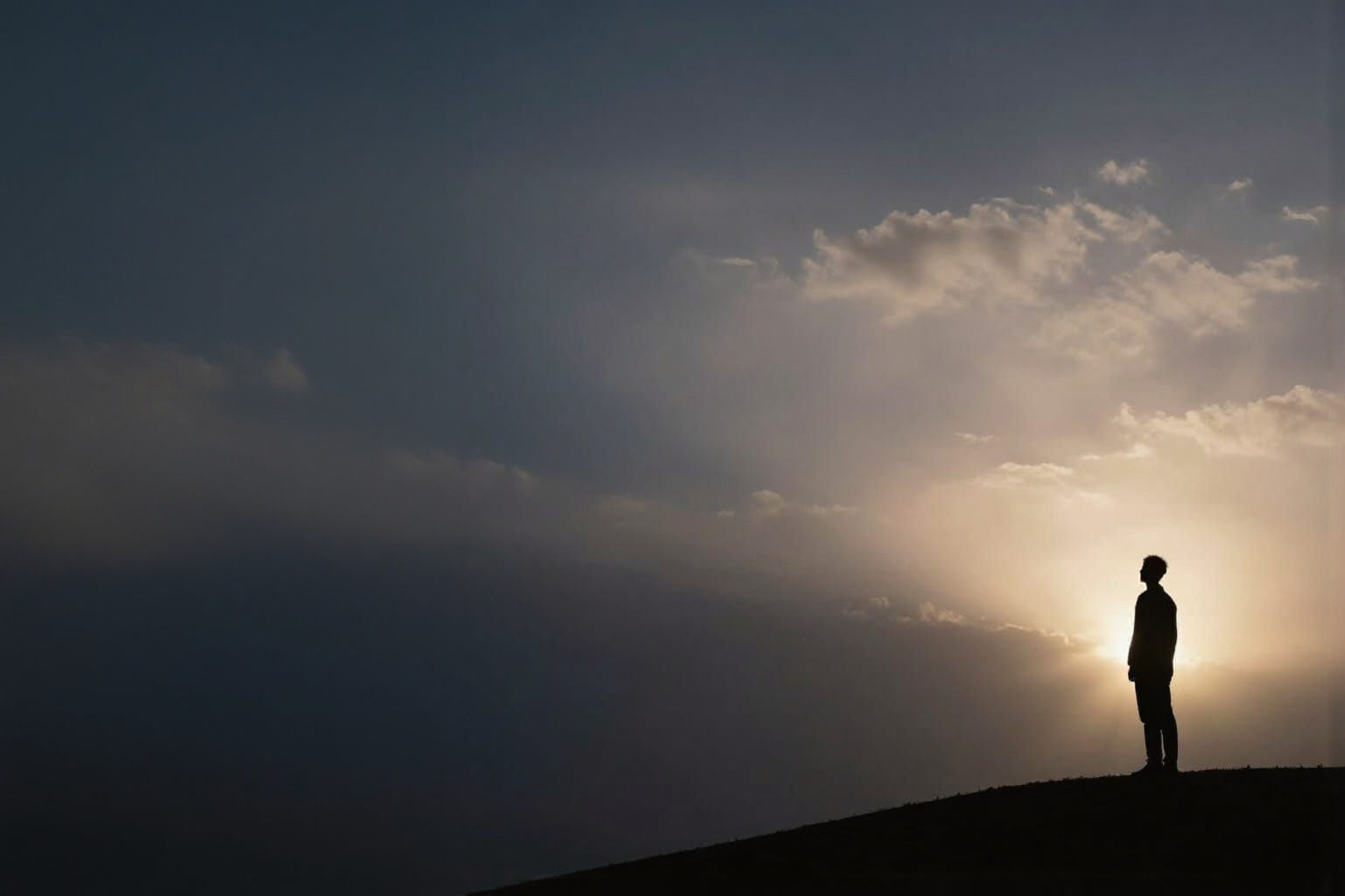 Human Silhouette at Sunrise Over Vast Sky