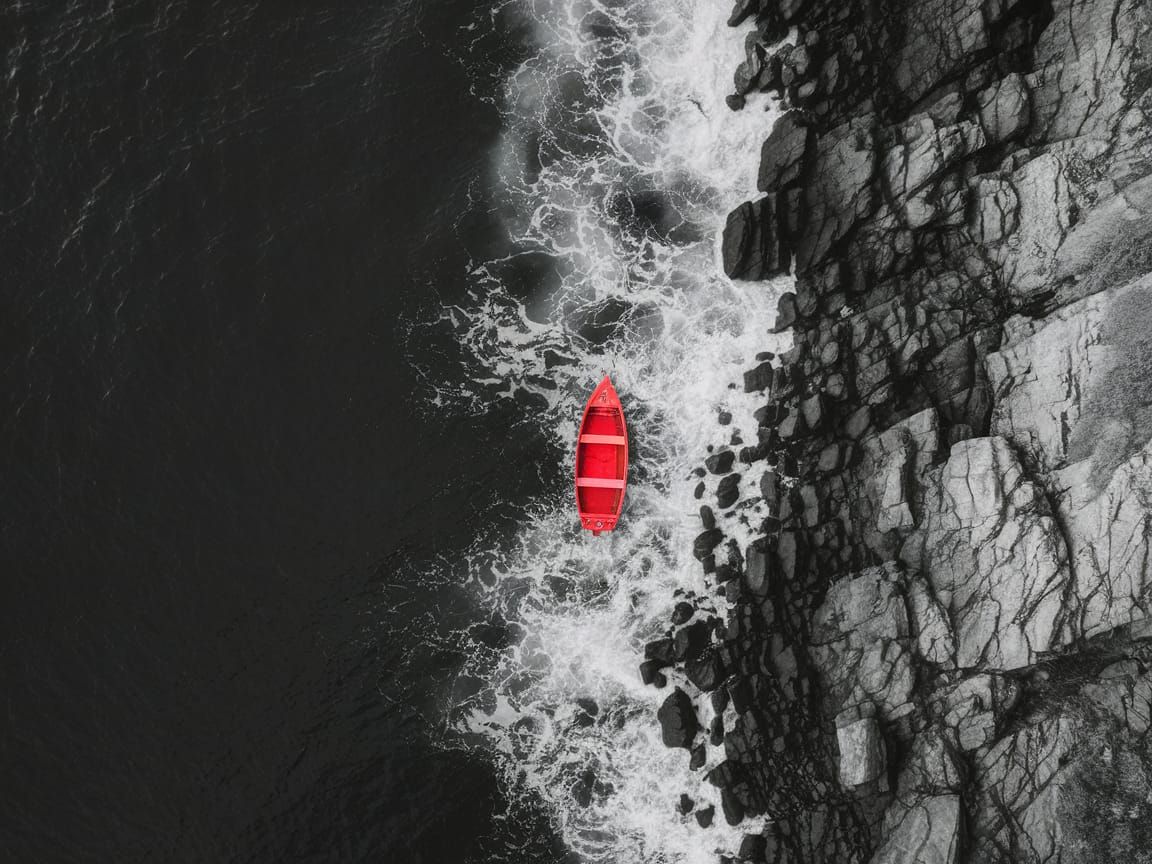 Rugged Coastline with Red Boat