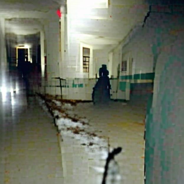 Silhouette Figure in Abandoned Hospital