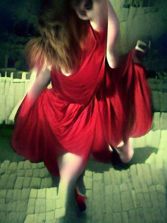 Woman Dancing in Red Dress Under Moonlight