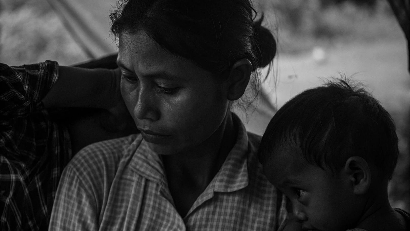 Contemplative Mother Embraces Children