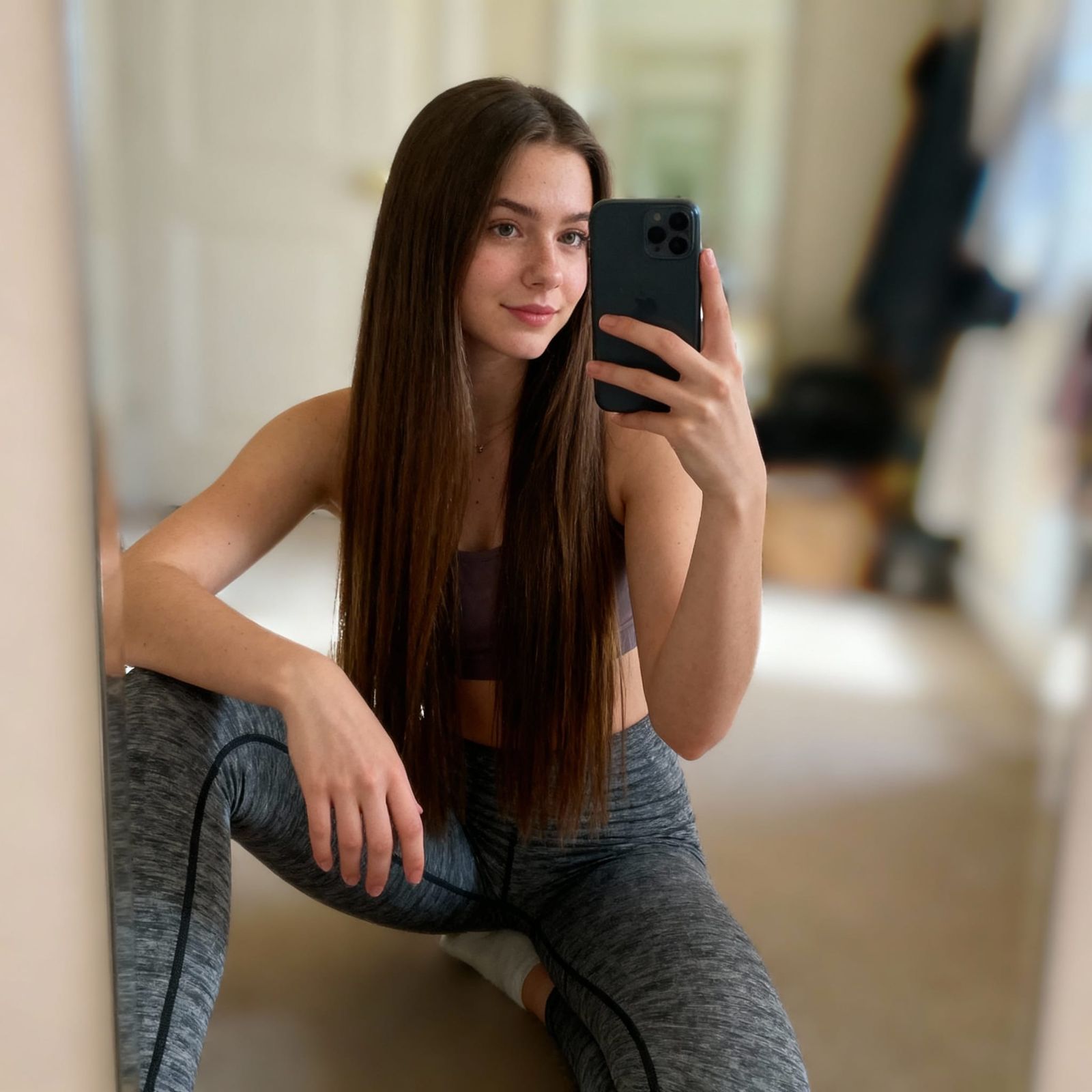 Woman Takes Mirror Selfie in Soft Lighting