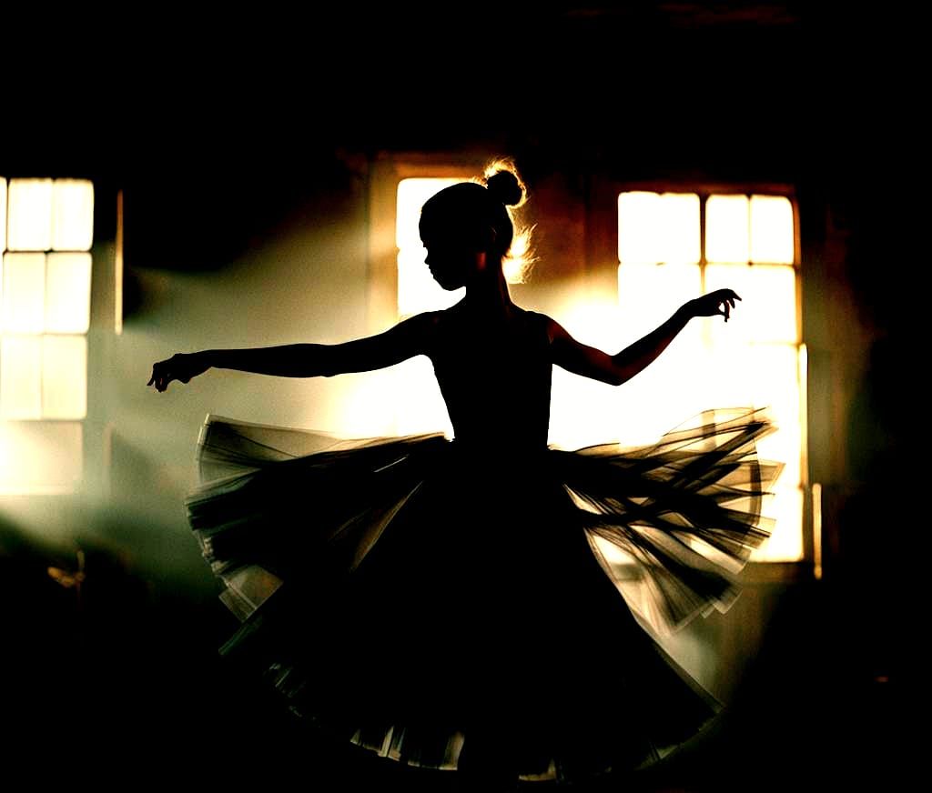 Girl in Black Dress Twirling in Dark Room