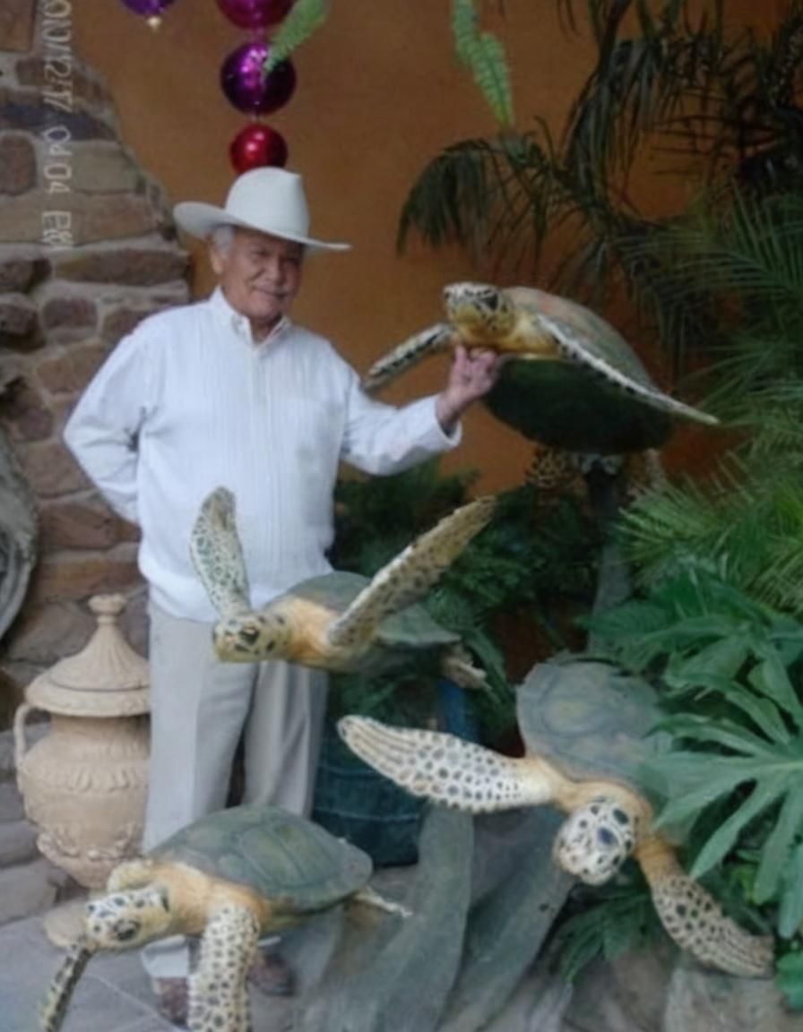 Man and Metal Turtle Sculpture