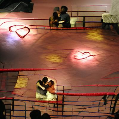 Romantic Couple Embracing in Boxing Ring