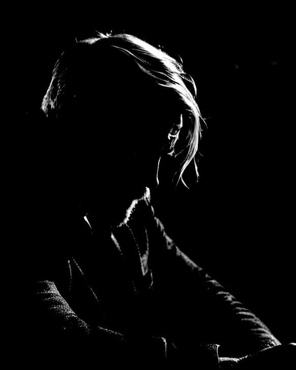 Contemplative Man in Concrete Room with Whiskey