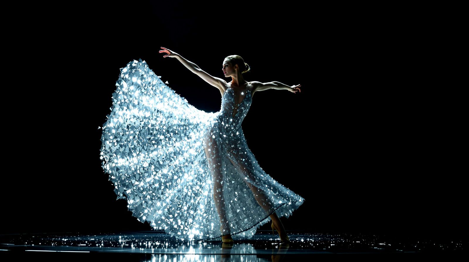 Dazzling Dancer in Glass Shard Dress on Dark Stage