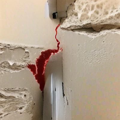 Abstract Red Liquid Seeping Through White Surface