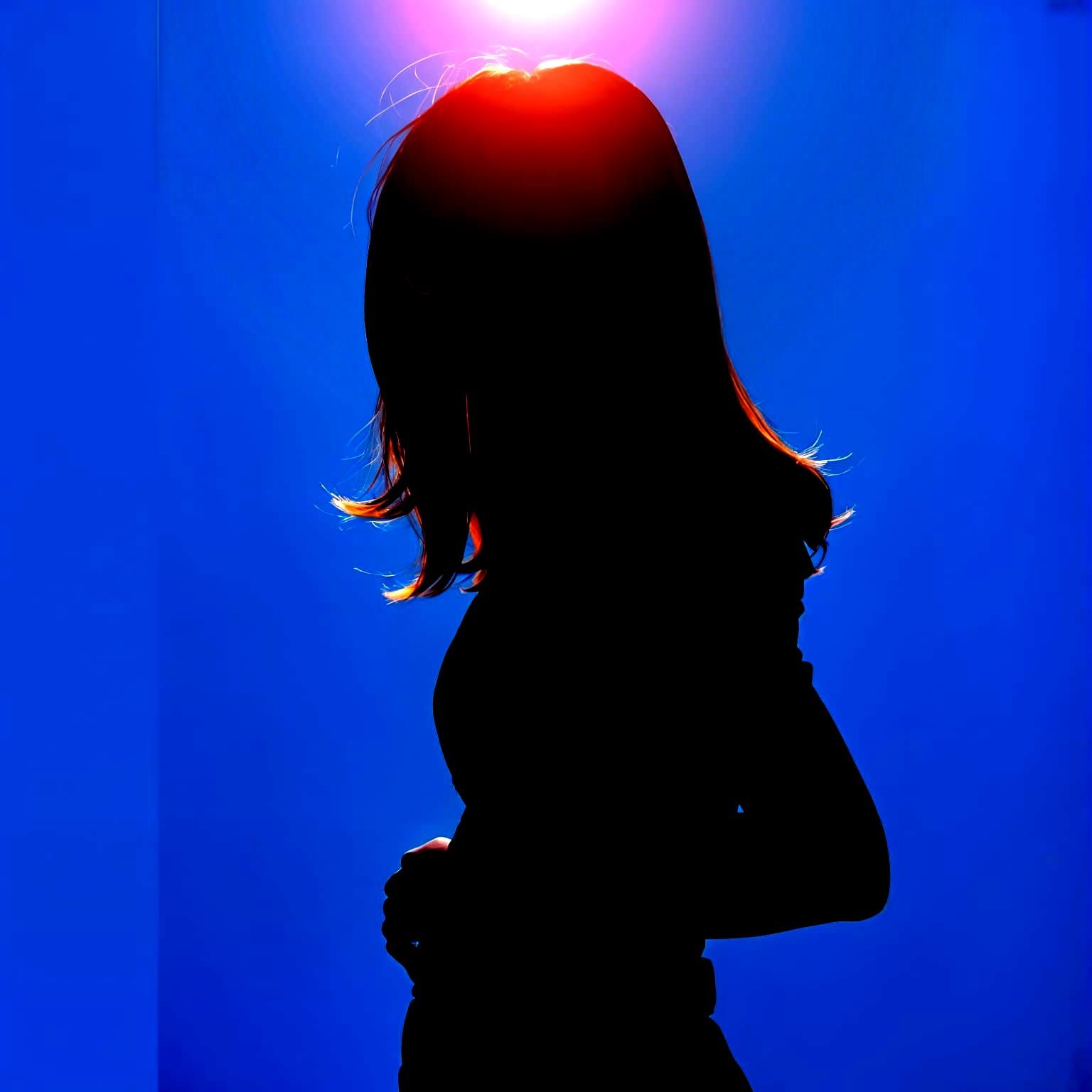 Modern Asian Woman in Professional Attire Silhouetted Agains...