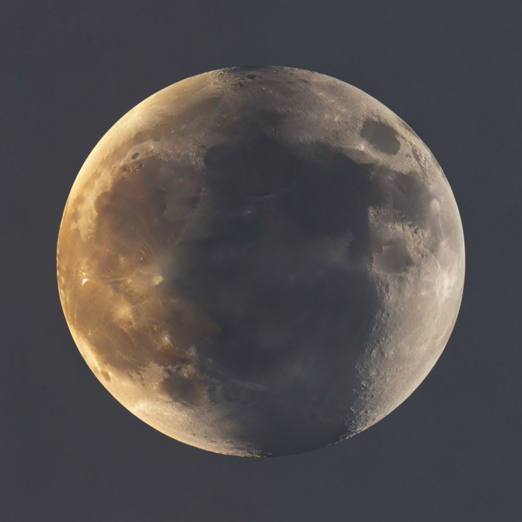 Dual Celestial Bodies: Yellow Moon and Gray Sun in Sky