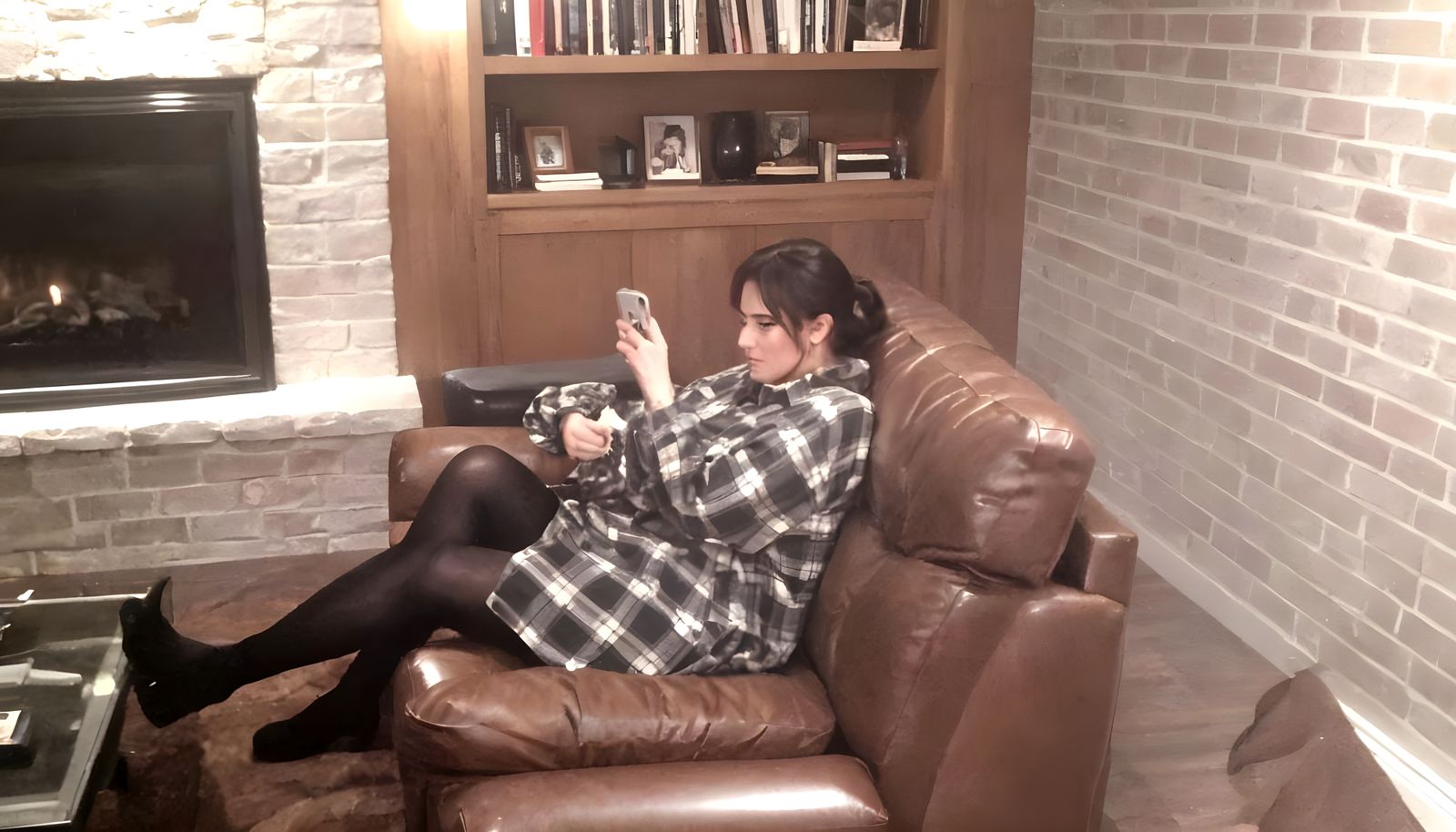 Woman Lounging on Brown Leather Sofa