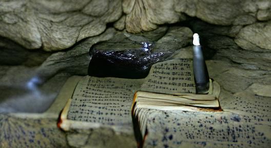 Old Book on Stone Altar in Dark Cave