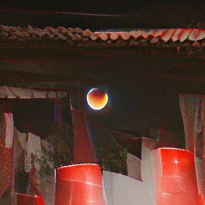 Dramatic Lunar Eclipse Over Starry Night