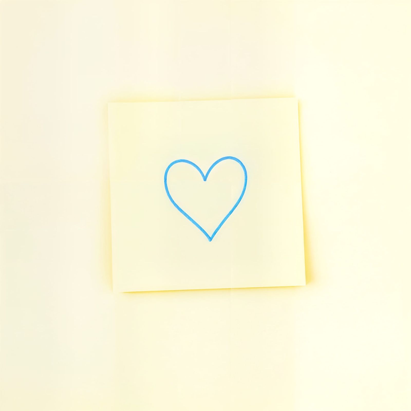 Vibrant Yellow Post-it Note with Heart Pencil Silhouette