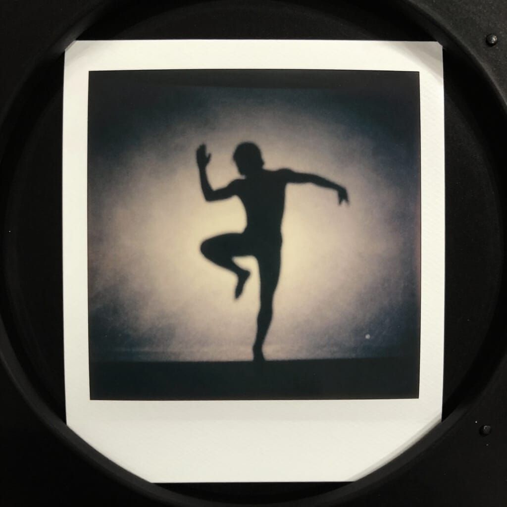 Shadowy Figure in Dynamic Pose: Vintage Polaroid