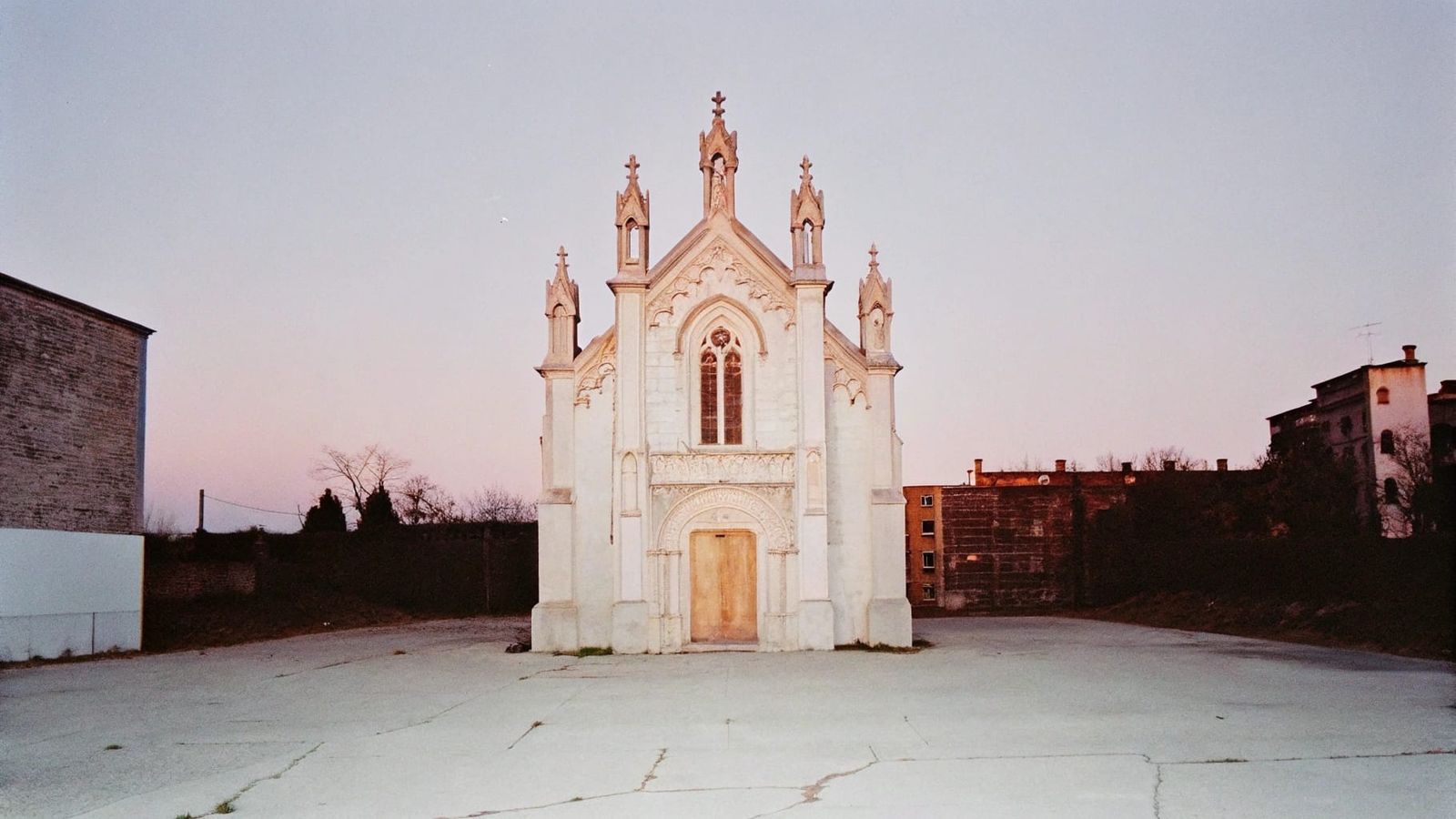 Gothic Church in Abandoned Cityscape at Dusk
