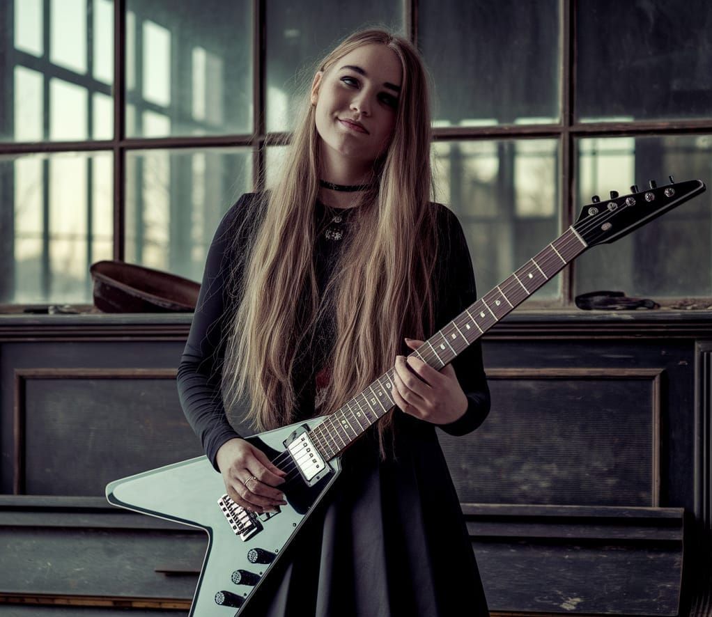Grunge Goddess Serenades in a Dusty, Sunlit Room