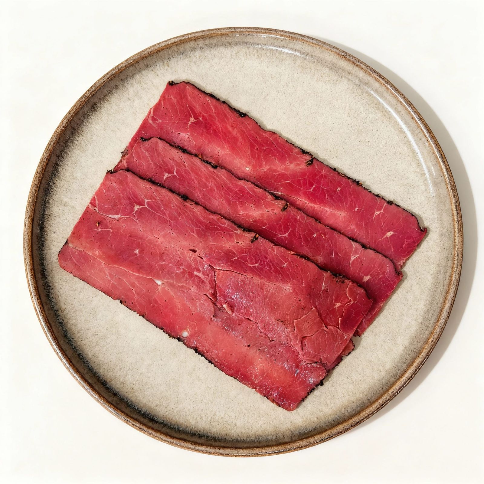 Pastrami Slices Artfully Arranged on a Round Plate
