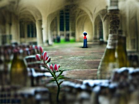 Figure Walking in Ancient Stone Cloister