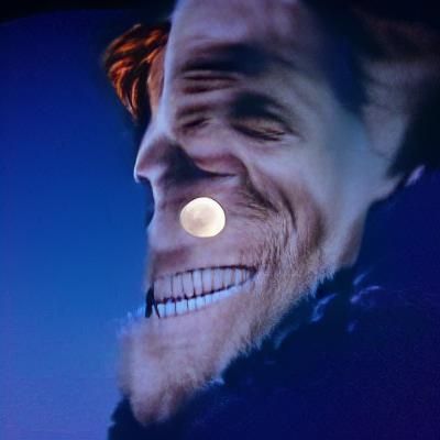 Willem Dafoe smiling at the moon