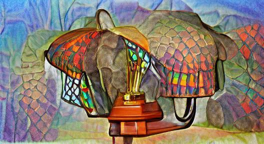 Colorful Tiffany lamp resting on top of wall mounted elephant head trophy; crosshatch color pencil sketch; saturated hue...