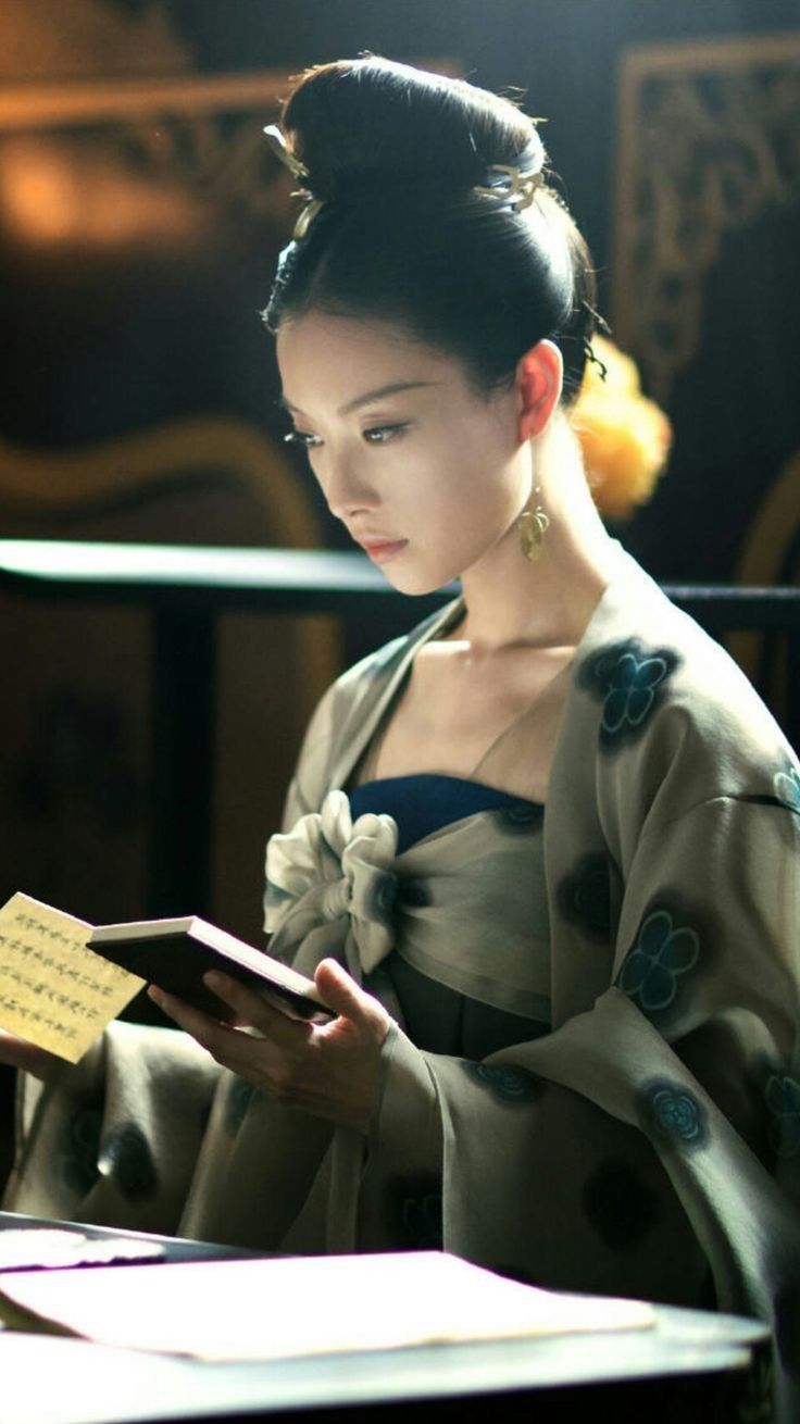 <lora:Ethereal Magic Flux:1.0>  Fantasy art. A witch stands among cherry blossoms. A gentle breeze blows her hair. Medium shot. Ethereal and...