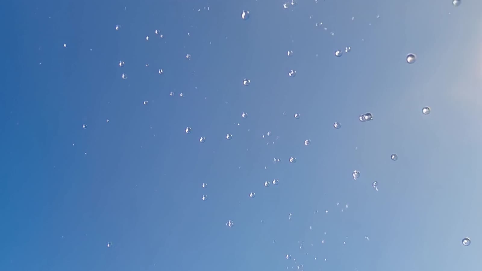 Rain drops frozen with a beautiful blue background