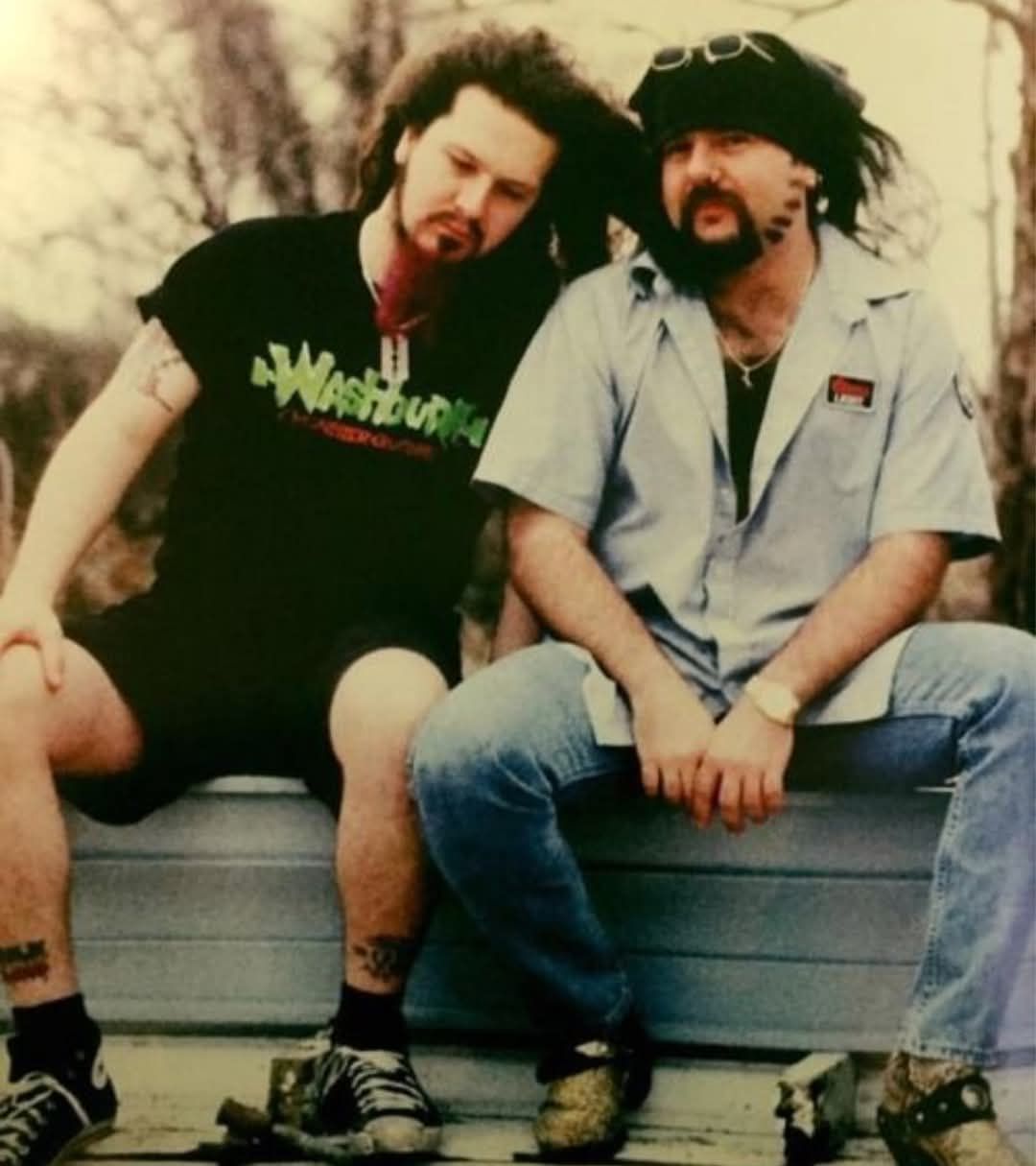 Smiling brothers wave at the viewer. The wind blows their hair as sun rays wash through bringing bokeh light dust.