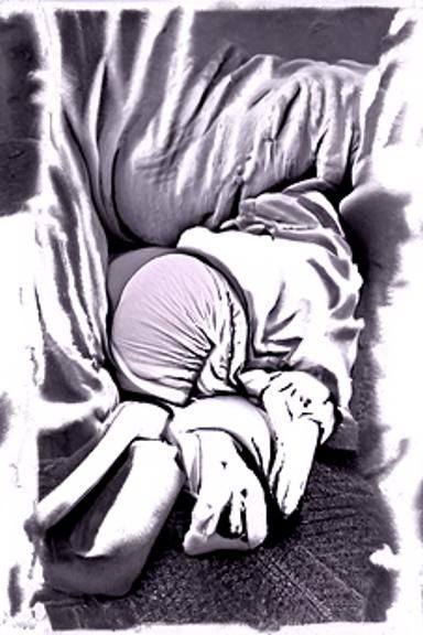 person cowering in fetal position