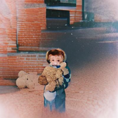 A cute little boy holding a teddy