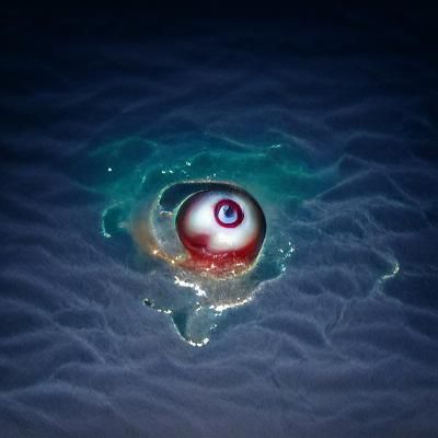 an eyeball floating in the ocean at night