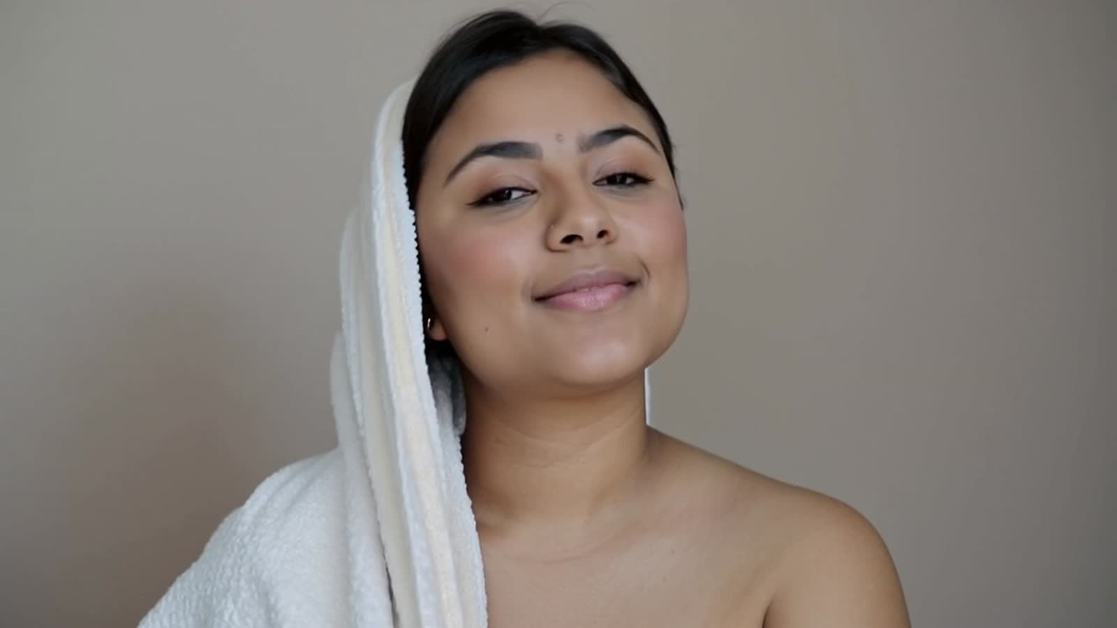 Indian sissy crossdresser , fair and chubby , in bath towel head also covered in bath towel standing in bedroom