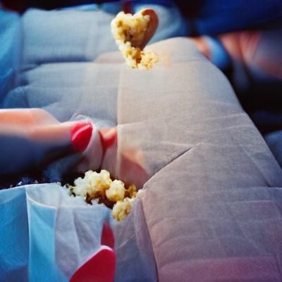 Going to the movies with your girlfriend while eating popcor...