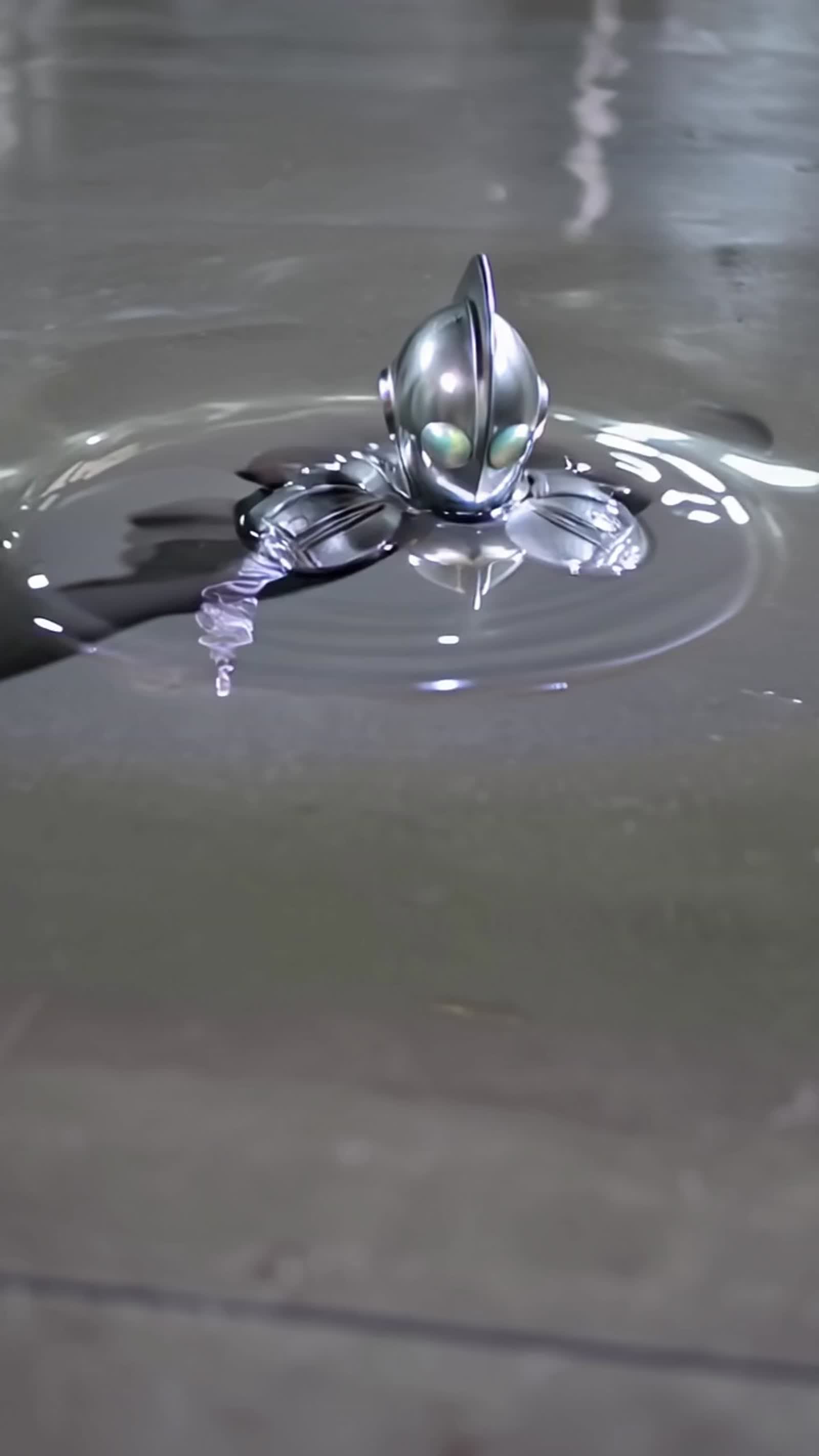 From a silvery puddle of mercury a metallic android emerges dripping and walks away