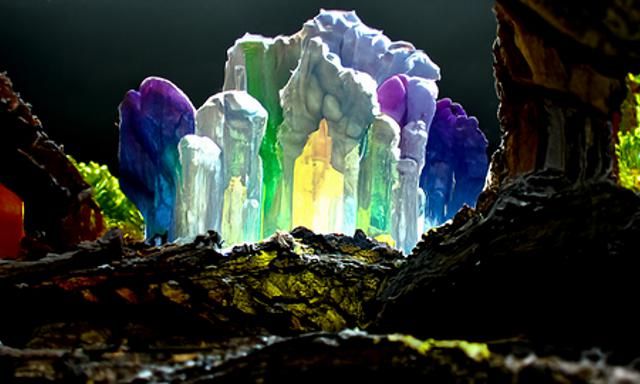 Rainbow crystal geodes growing as a stalagmite in a luscious cavern ...