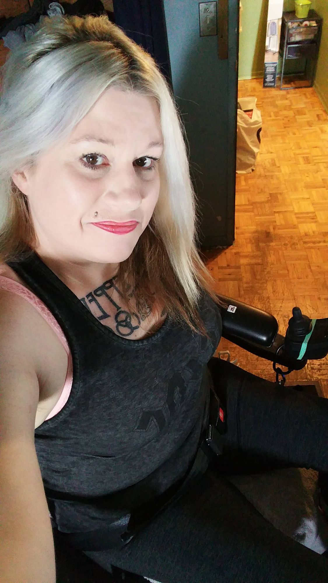 <lora:Kyoot:1.0> Big Hazel  brown-green eyes, Platinum blonde, tattoos, chest, Tank Top says : F*Ck Trudeau" tattoo that says "Led Zeppelin"...