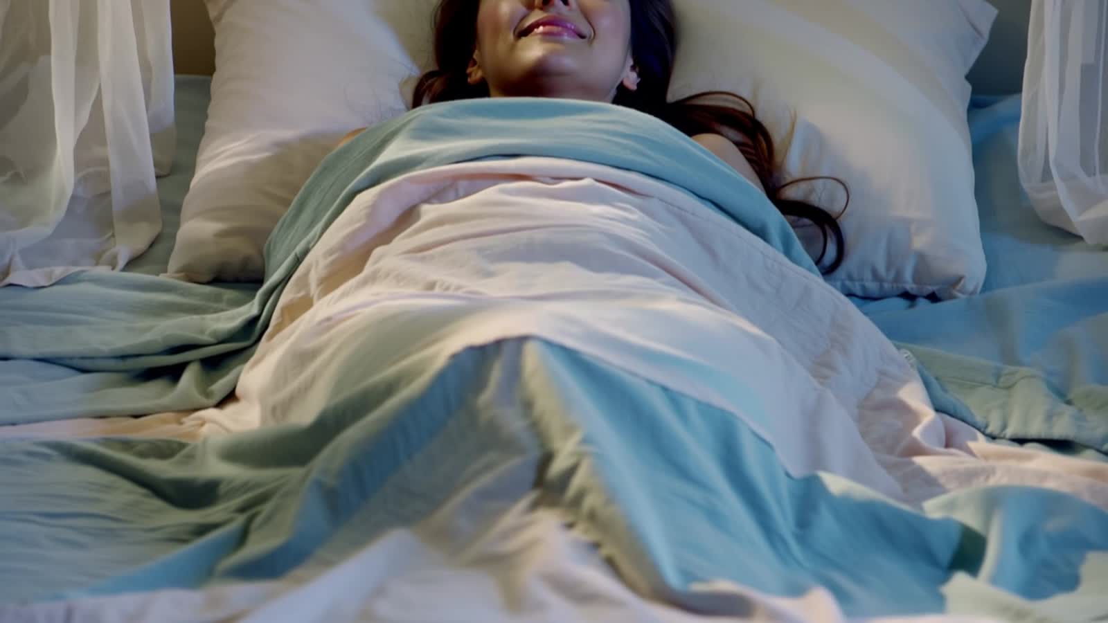 A woman in bed as her soul leaves her body in a glorious bright light surrounded by angels