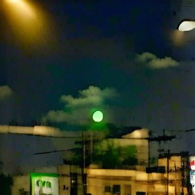 the moon bathed in green light