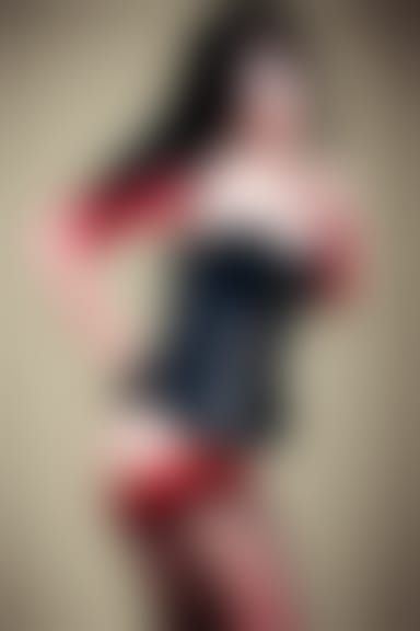 Teen with a black corset, red fishnets, and blue and black h...