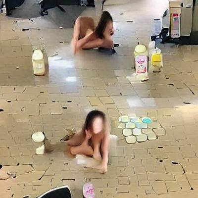 squatting naked girl on milk spilled floor