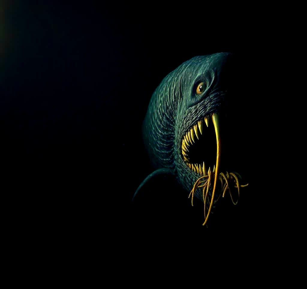 Creepy gargantuan eldritch sea monster creature looking at the viewer at the bottom of the Mariana’s trench