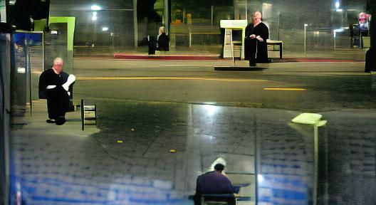 Catholic Priest at a Los Angeles bus stop. Nighttime. Lonely...