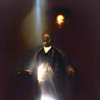A dark figure of a man in front of a blinding light