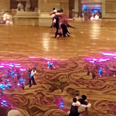Dancers in ballroom are dancing in the middle of the dancers