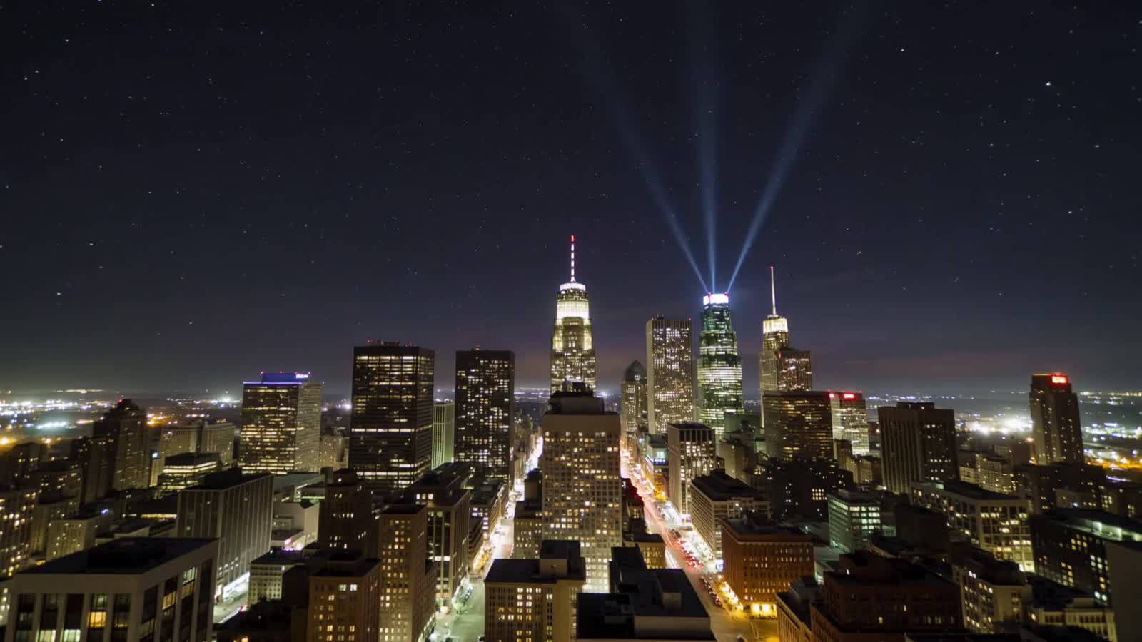 Ultra-fast time-lapse of a city skyline cycling from night to dawn and back to night in 5 seconds. Vibrant light trails,...