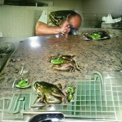 My uncle eating frogs in a dim kitchen 