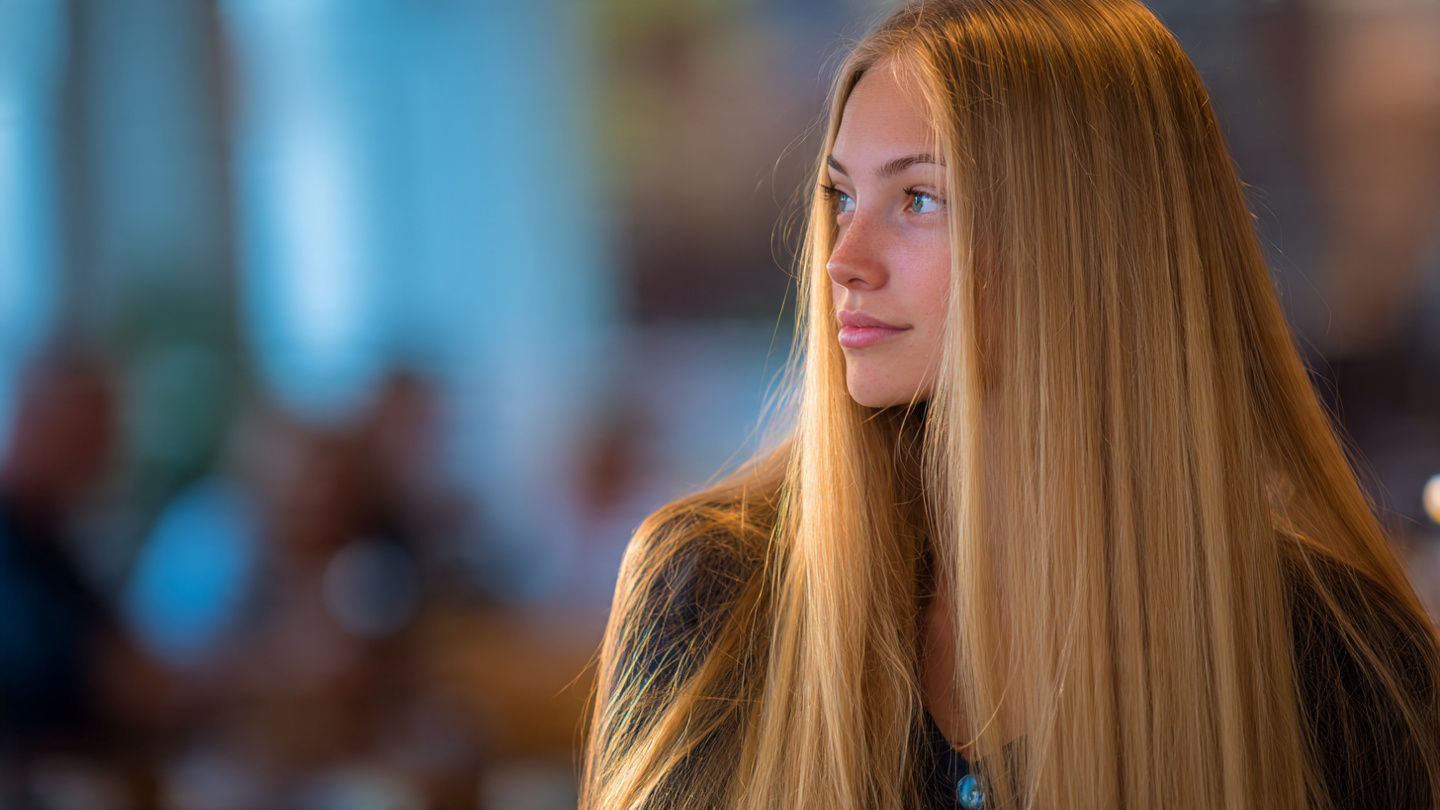 a young blonde woman looks to one side  by @RJself