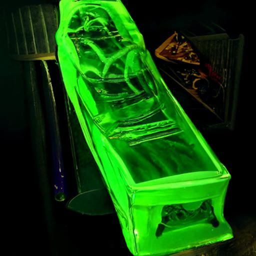 Uranium glass coffin and ultraviolet light on black velvet