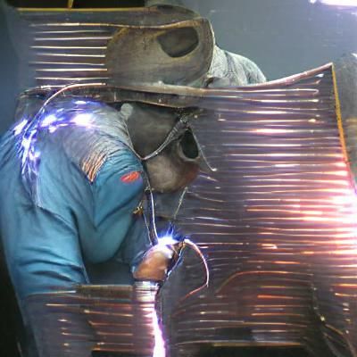 Welder welding a piece of metal